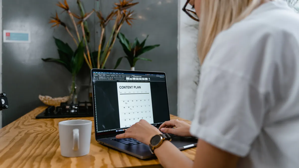Person planning blog content on a laptop