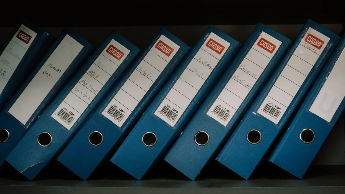 Blue ring binders on a shelf