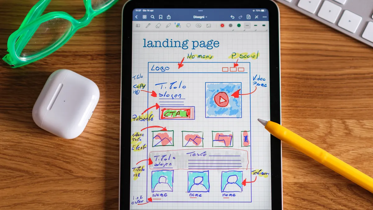 Tablet with sketched landing page wireframe and stylus