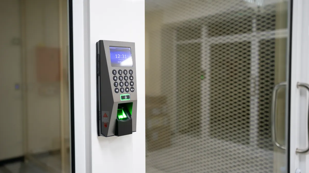 Keypad door access control beside a glass entrance