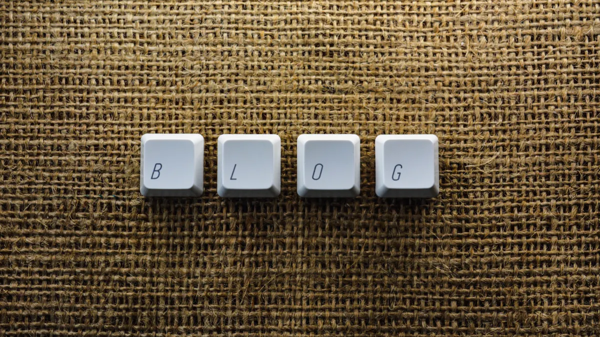How does AI blog publishing fit into an editorial workflow? — Close-up of Individual Keyboard Keys Making a Word "Blog"