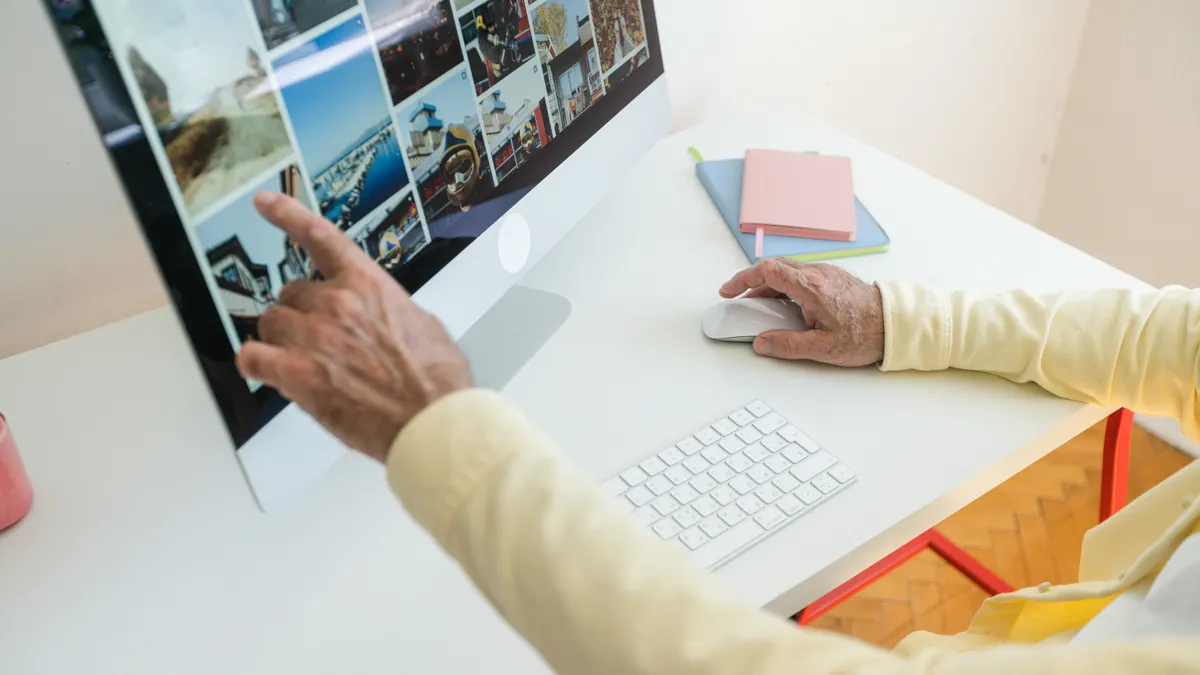 Person editing a grid of images on a desktop computer