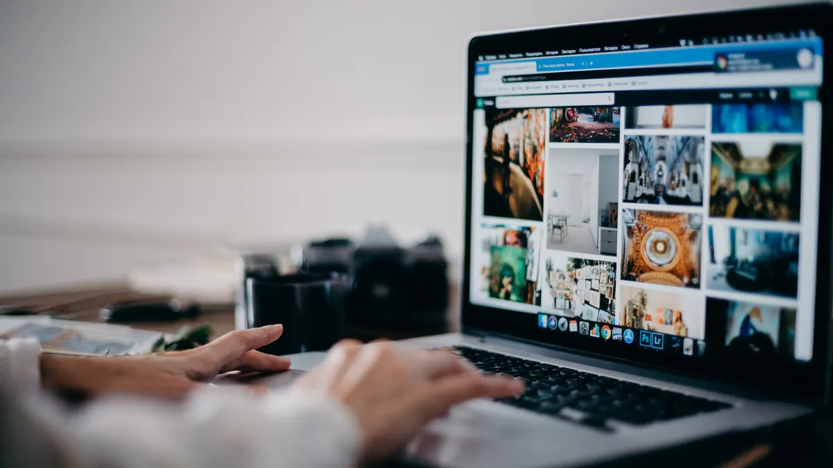 Person browsing a photo gallery on a laptop