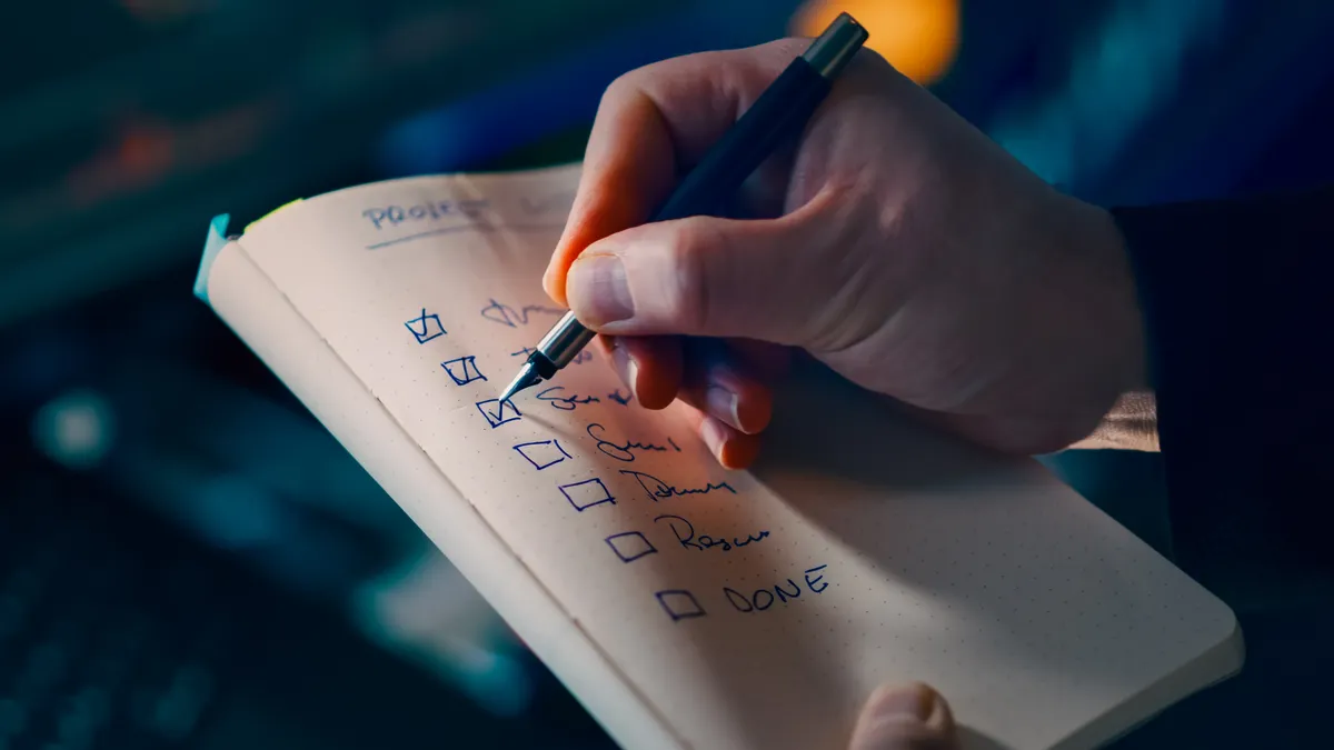 hand checking items on a checklist