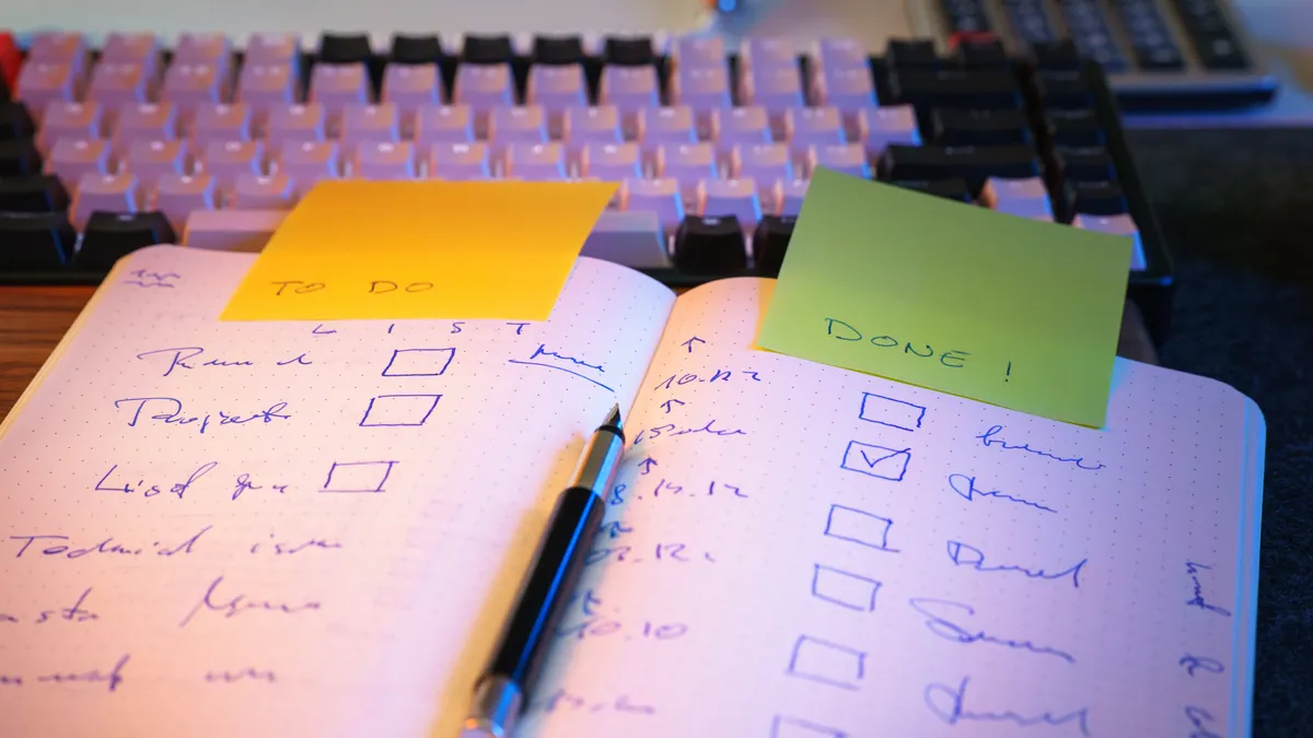 open notebook checklist with boxes and sticky notes