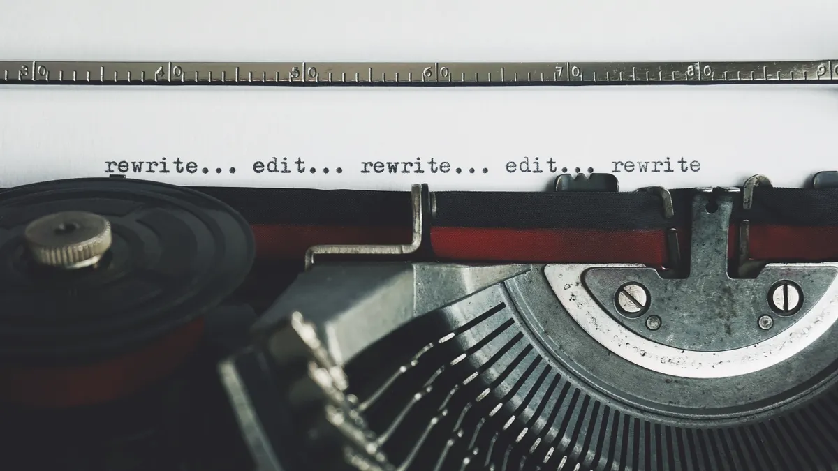 typewriter paper with repeated rewrite and edit text